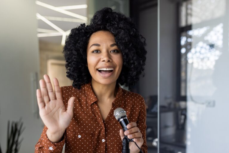 Businesswoman speaking into microphone with enthusiasm